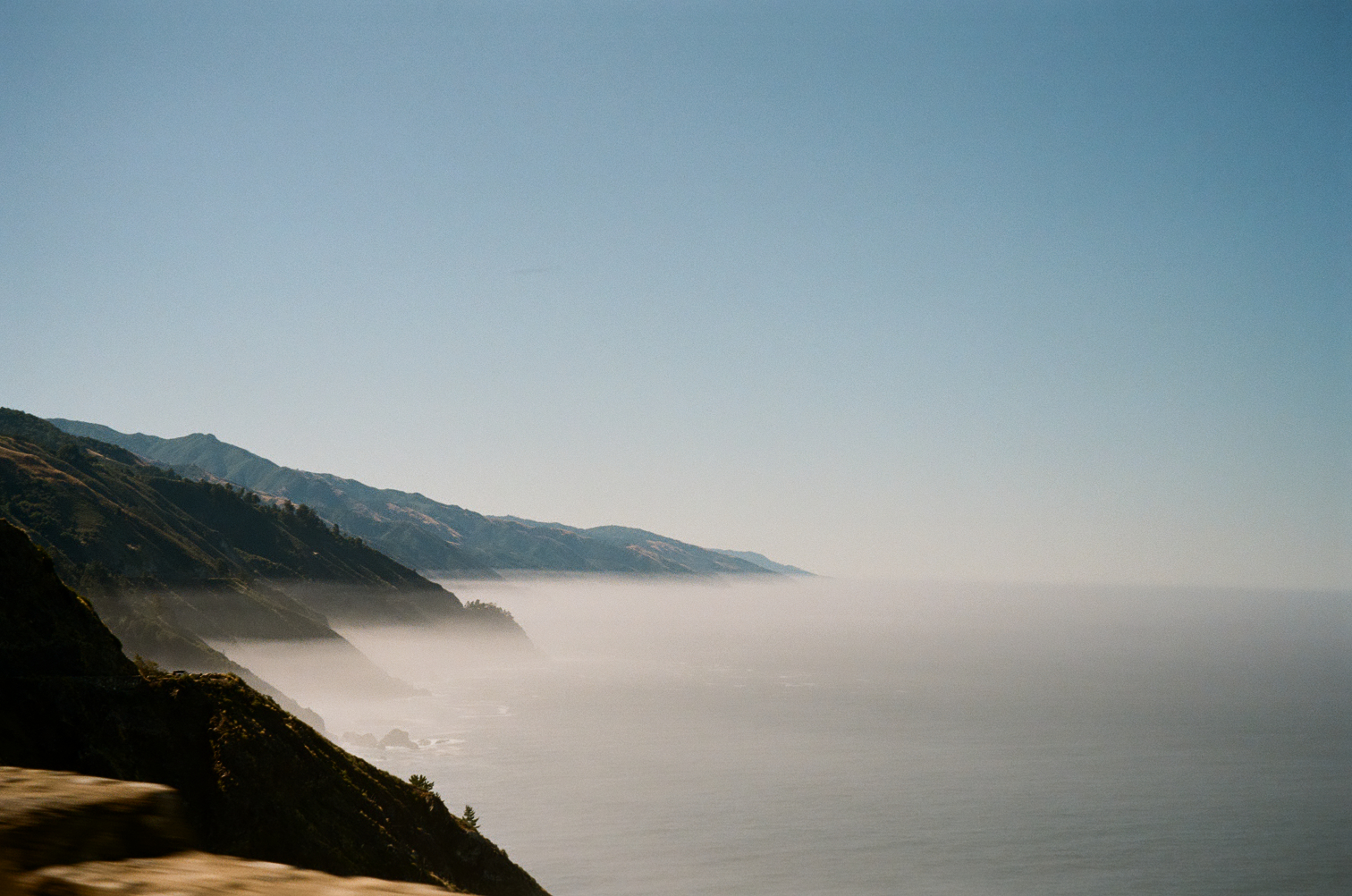 Coastal hills receding into fog